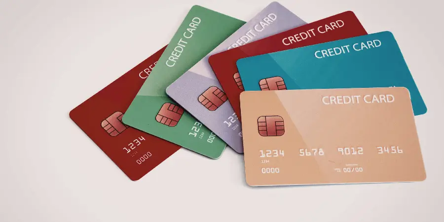 Multiple colorful credit cards stacked together showing standard size, useful everyday object for comparing and estimating length
