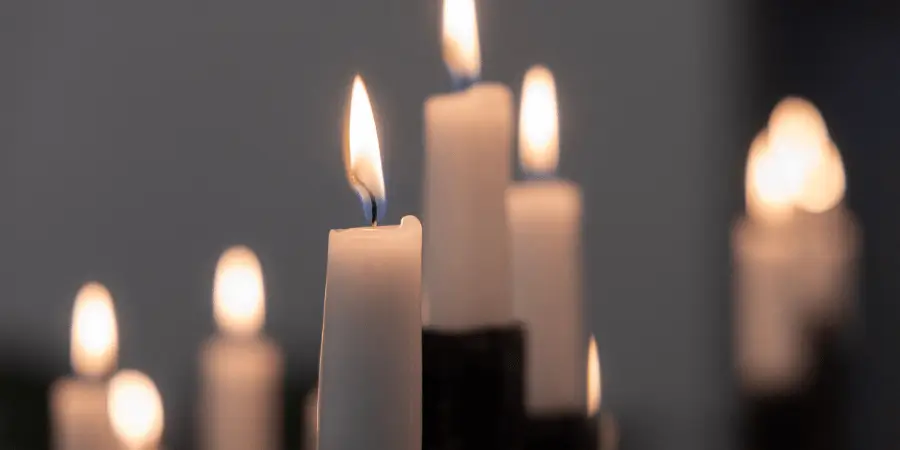 Small candle burning with soft light, representing a common household item close to 6 inches in height for quick and simple size comparison