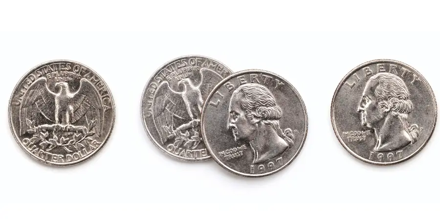 US quarters arranged in a row showing both heads and tails sides, coin detail and metallic texture visible