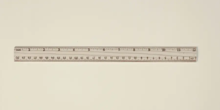Wooden ruler with inch markings from 0 to 12 displayed flat, where half length represents 6 inches for accurate measurement