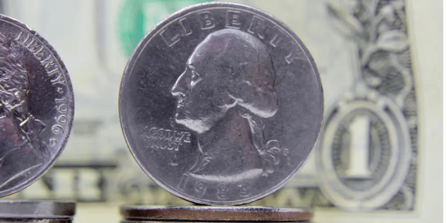 Close up image of US quarter coin beside dollar bill for everyday size estimation reference
