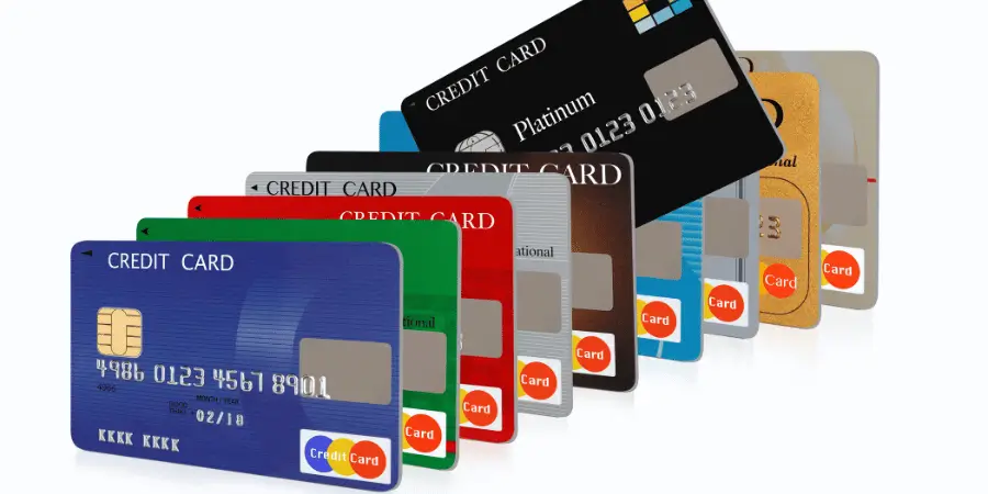 Multiple credit cards arranged in overlapping rows on white background showing standard card dimensions clearly