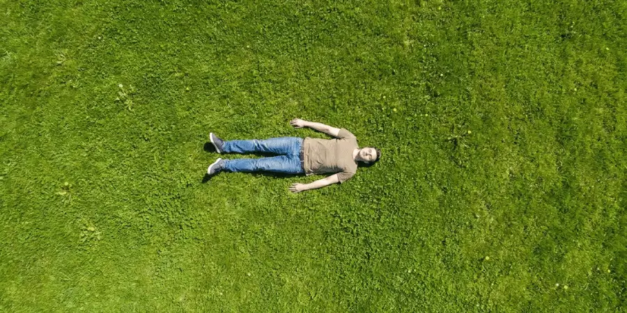 Adult lying on grass