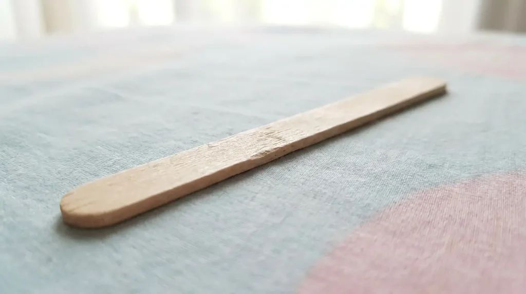 Wooden popsicle stick measuring close to five inches
