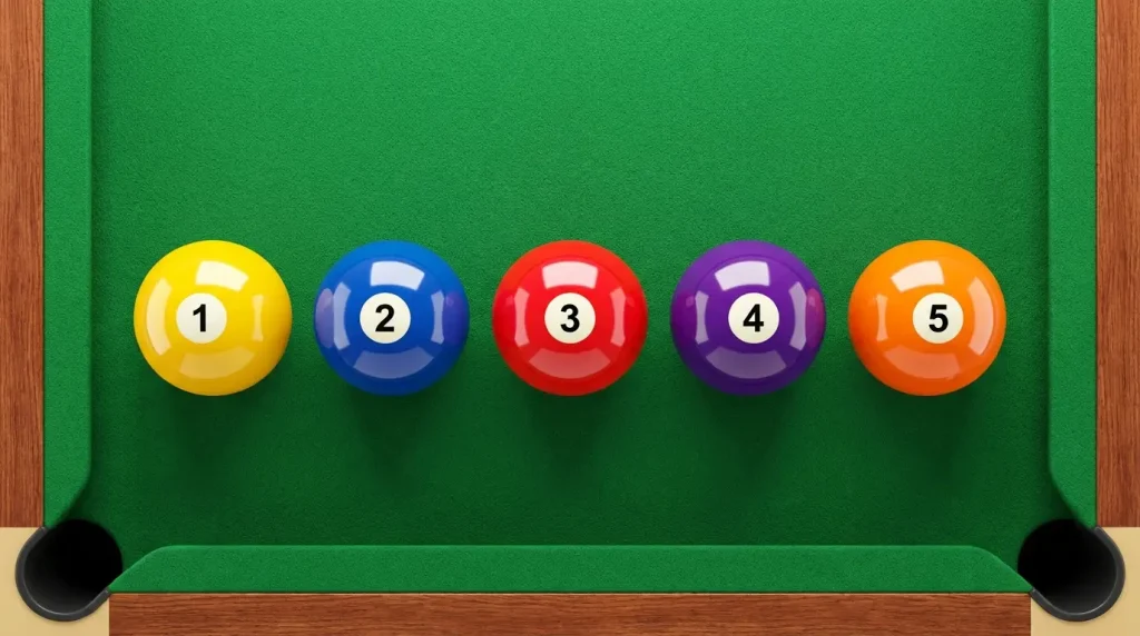Five billiard balls lined up to show an eleven inch length reference at home